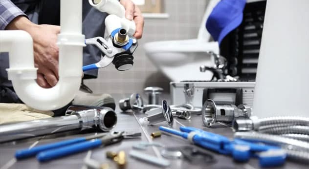 Homeowner practicing simple plumbing maintenance habits to prevent issues
