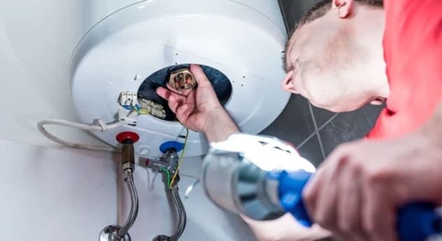 Homeowner practicing simple plumbing maintenance habits to prevent issues